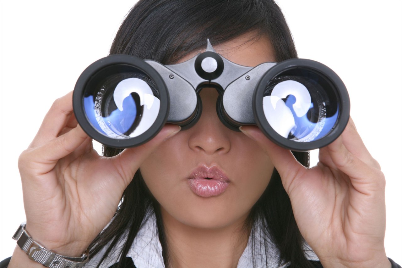Woman looking through a pair of binoculars